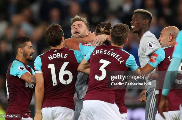 Andy Carroll of West Ham United pushes Luke Shaw of Manchester United in the neck during the Premier League match between West Ham United and...