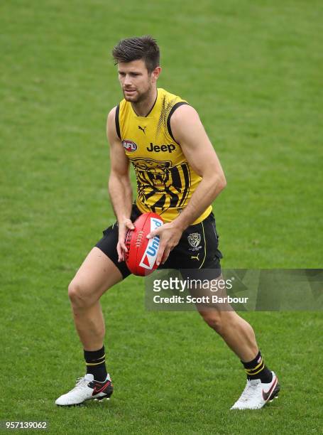 Trent Cotchin of the Tigers runs with the ball during a Richmond Tigers AFL training session at Punt Road Oval on May 11, 2018 in Melbourne,...