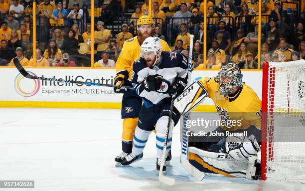 Bryan Little of the Winnipeg Jets battles between Pekka Rinne and Ryan Ellis of the Nashville Predators in Game Seven of the Western Conference...