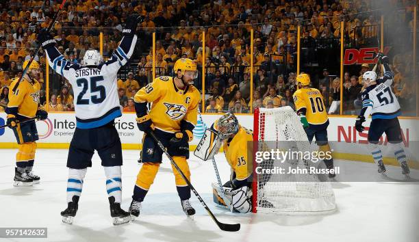 Tyler Myers and Paul Stastny of the Winnipeg Jets celebrate a goal against Pekka Rinne and Roman Josi of the Nashville Predators in Game Seven of the...