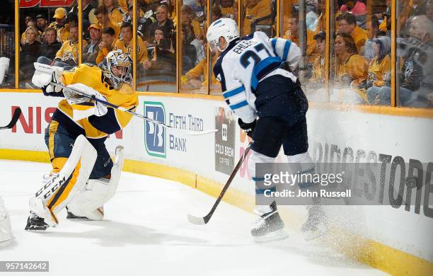 Juuse Saros of the Nashville Predators clears the puck against Nikolaj Ehlers of the Winnipeg Jets in Game Seven of the Western Conference Second...