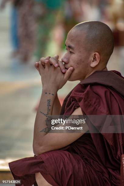monk in a pensive mood. - saffron robes stock pictures, royalty-free photos & images