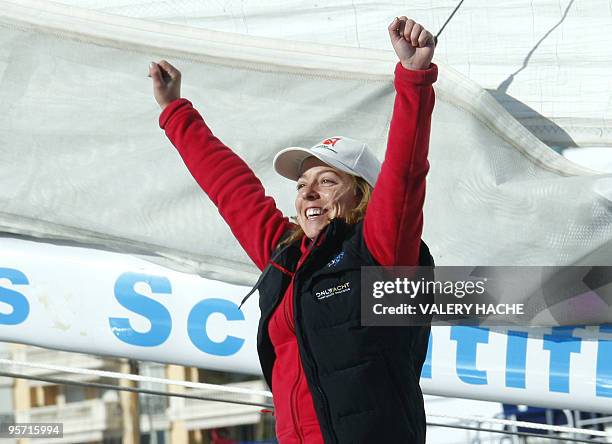 Skipper Alexia Barrier of Monaco waves on her sailing boat '4MyPlanet' in Monaco harbor, on January 11, 2010 before her departure for a solo...