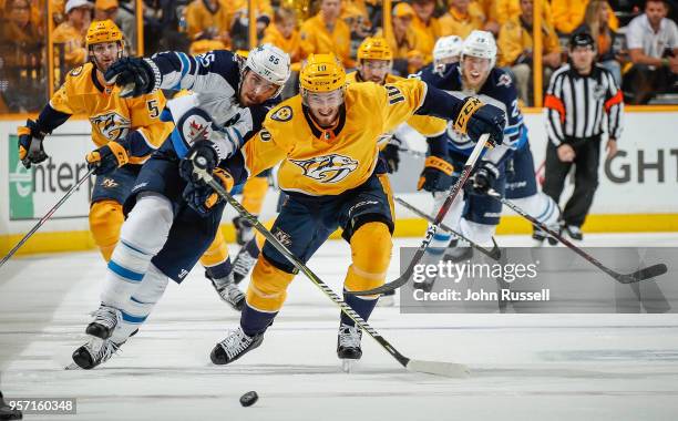 Colton Sissons of the Nashville Predators battles for the puck against Mark Scheifele of the Winnipeg Jets in Game Seven of the Western Conference...