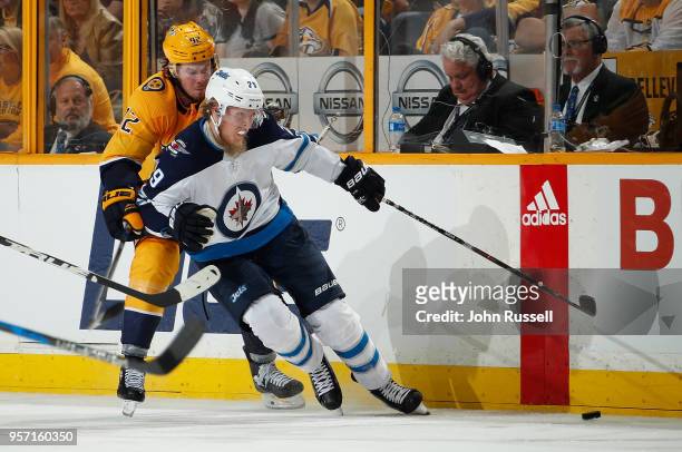 Patrik Laine of the Winnipeg Jets skates against Ryan Johansen of the Nashville Predators in Game Seven of the Western Conference Second Round during...