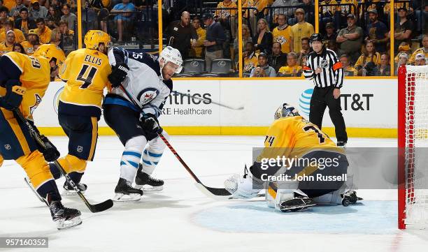 Paul Stastny of the Winnipeg Jets scores against Juuse Saros of the Nashville Predators as Ryan Ellis defends in Game Seven of the Western Conference...