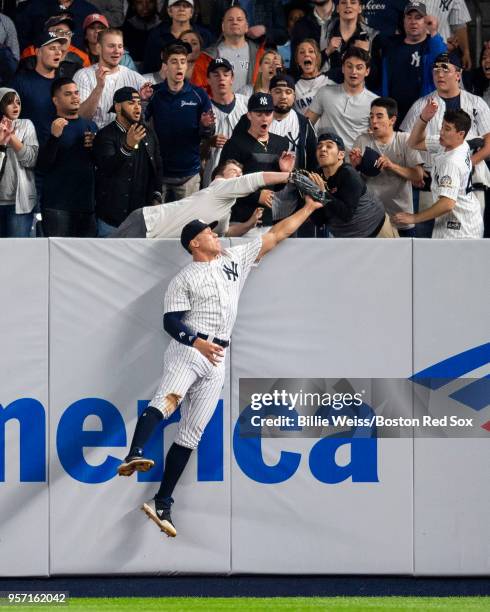 Aaron Judge leaps at the wall but can't come up with the ball off the bat of J.D. Martinez of the Boston Red Sox for the go-ahead run in the eighth...