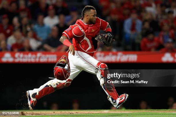 Martin Maldonado of the Los Angeles Angels of Anaheim chases a pass ball during the sixth inning of a game against the Minnesota Twins at Angel...