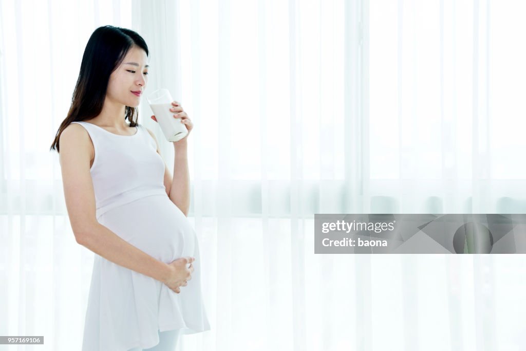 Pregnant woman drinking milk