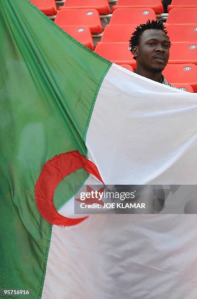 An Algerian fan holds his country flag during the African Cup of Nations football championships CAN2010 group stage match Algeria vs. Malawi at...