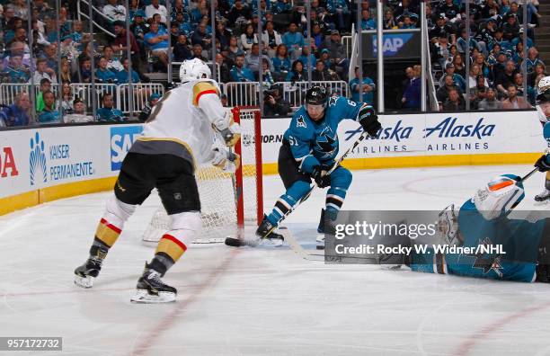 Justin Braun and Martin Jones of the San Jose Sharks attempt to save the puck against Brayden McNabb of the Vegas Golden Knights in Game Six of the...