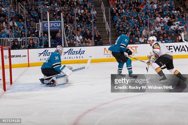 Jonathan Marchessault of the Vegas Golden Knights scores a goal against Martin Jones and Justin Braun of the San Jose Sharks in Game Six of the...