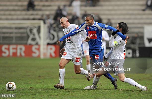 Amiens' midfielder Samuel Allegro and Amiens' player Benoit Haaby vies with Auxerre's forward Daniel Niculae during their French Cup football match,...