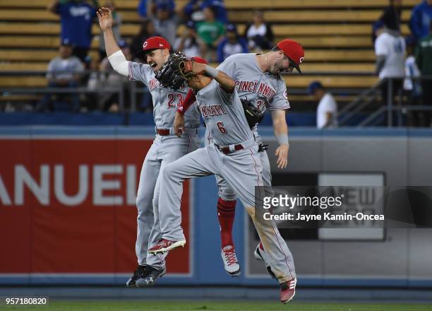 Outfielders Adam Duvall Billy Hamilton and Jesse Winker of the Cincinnati Reds jump in the air as they celebrate defeating the Los Angeles Dodgers at...