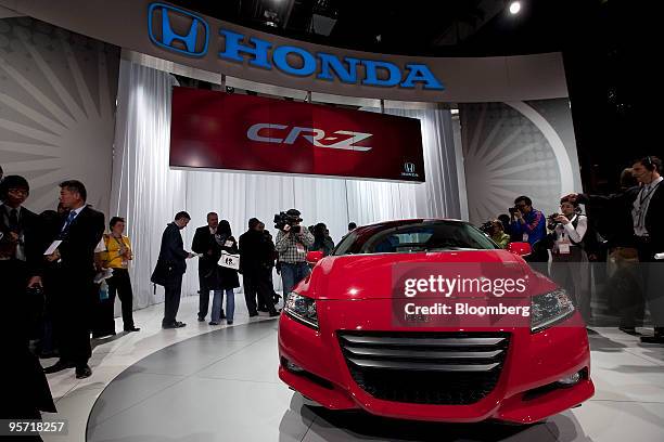 Members of the media look at the Honda Motor Co. CR-Z hybrid after its unveiling on day one of the 2010 North American International Auto Show in...