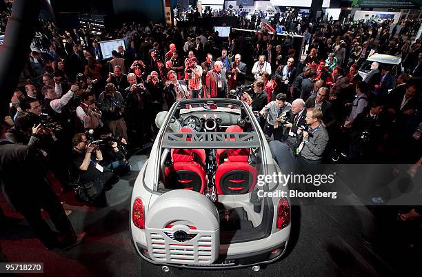 Members of the media look at a Bayerische Motoren Werke AG Mini Beachcomber concept following its unveiling on day one of the 2010 North American...