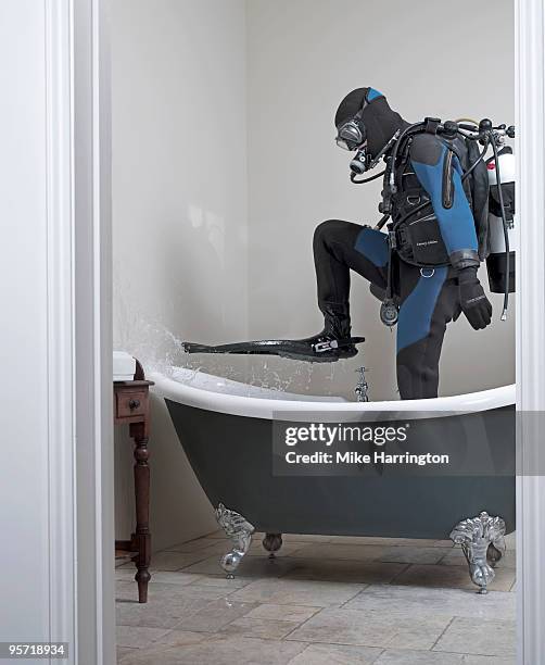 scuba diver standing in a bath - diving equipment stock pictures, royalty-free photos & images