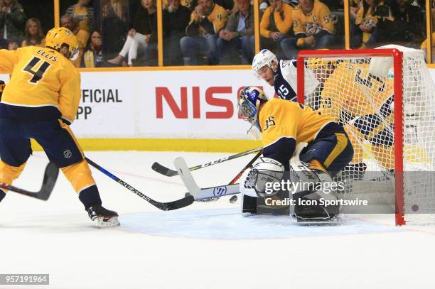 Nashville Predators defenseman Roman Josi defends against Winnipeg Jets center Paul Stastny as Nashville Predators goalie Pekka Rinne protects the...