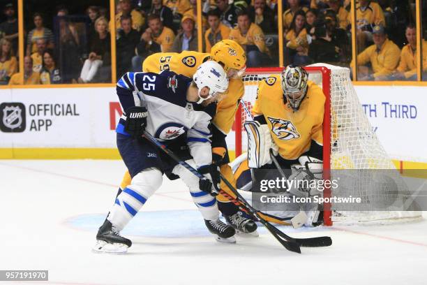 Nashville Predators defenseman Roman Josi defends against Winnipeg Jets center Paul Stastny as Nashville Predators goalie Pekka Rinne looks for the...