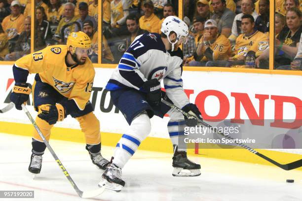 Nashville Predators center Nick Bonino defends against Winnipeg Jets center Adam Lowry during Game Seven of Round Two of the Stanley Cup Playoffs...