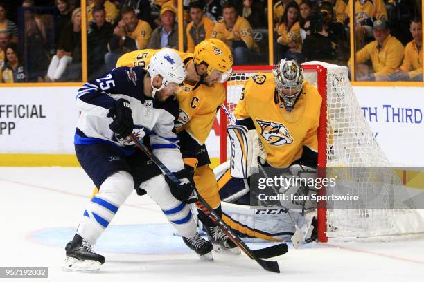 Winnipeg Jets defenseman Tyler Myers scores between the skate of Nashville Predators goalie Pekka Rinne and the post during the first period of Game...