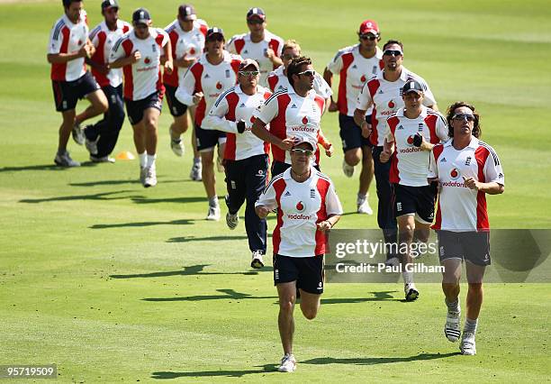 Captain Andrew Strauss leads the warm up alongside team-mate Ryan Sidebottom during an England nets session at The Wanderers Cricket Ground on...