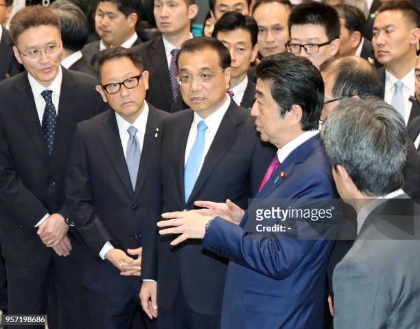 Chinese Premier Li Keqiang and Japanese Prime Minister Shinzo Abe visit the Toyota Motor Hokkaido in Tomakomai, Hokkaido prefecture on May 11, 2018...