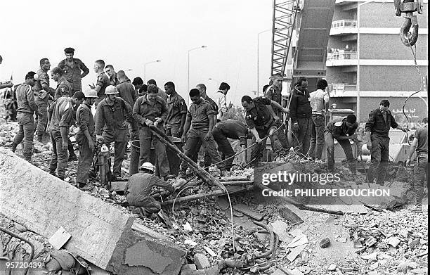 Rescuers search for survivors 25 October 1983 in Beirut through the rubble of the -Drakkar- building which was destroyed by a suicide truck bomber...