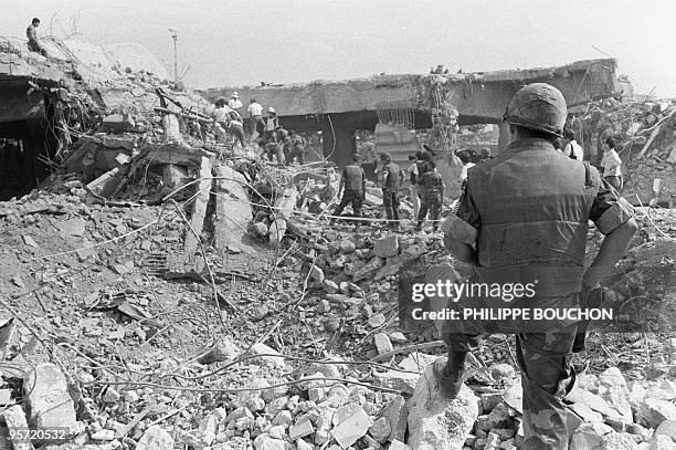 Soldiers search the debris 28 October 1983 after a terrorist attack on a US military barrack killed 241 American soldiers 23 October in Beirut.
