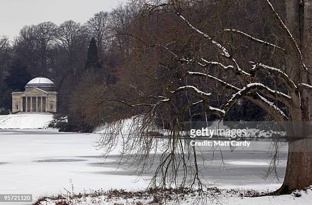 Branches from a tree fall to the frozen lake at the National Trust's Stourhead near Warminster on January 12, 2010 in Wiltshire, England. Much of UK...