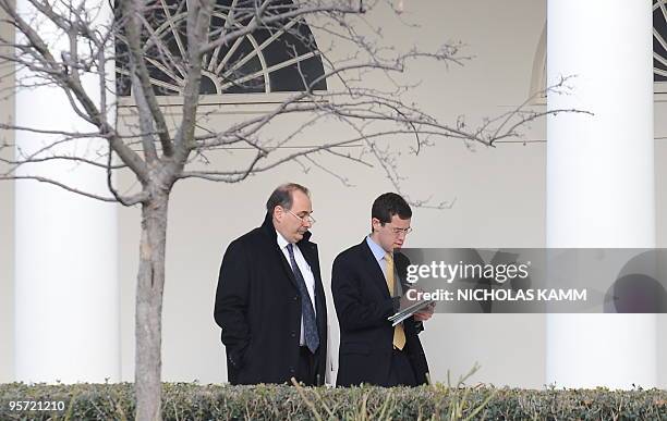 David Axelrod, senior advisor to US President Barack Obama, and an aide walk through the Colonnade at the White House in Washington,DC on January 12,...