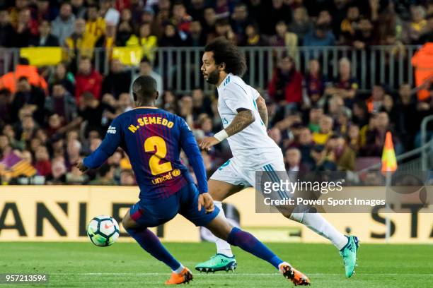 Marcelo Vieira Da Silva of Real Madrid is tackled by Nelson Cabral Semedo of FC Barcelona during the La Liga match between Barcelona and Real Madrid...