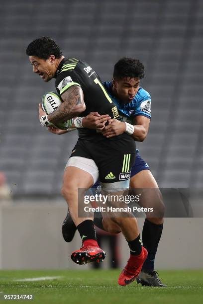 Ben Lam of the Hurricanes is tackled by Rieko Ioane of the Blues during the round 12 Super Rugby match between the Blues and the Hurricanes at Eden...