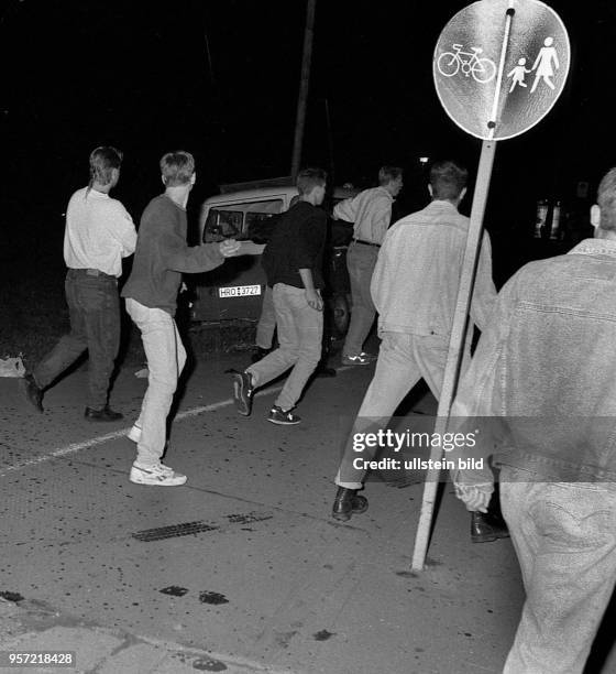 Jugendliche beim Angriff auf einen unbesetzten Einsatzwagen der Polizei am 27.8.1992 vor der Zentralen Aufnahmestelle für Asylbewerber in der...