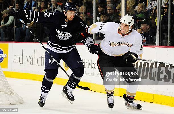 Troy Bodie of the Anaheim Ducks skates against Alexander Sulzer of the Nashville Predators on January 9, 2010 at the Sommet Center in Nashville,...