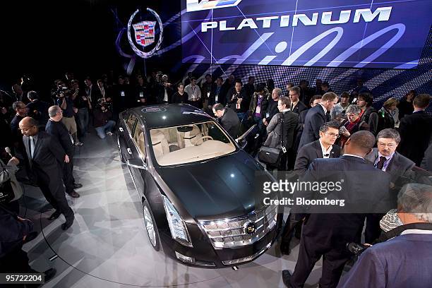 Members of the media look at General Motors Co.'s Cadillac XTS Platinum Concept plug-in hybrid following its unveiling on day two of the 2010 North...