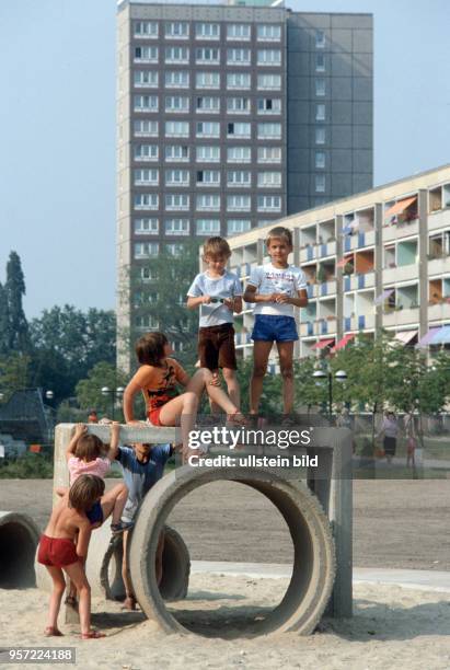 Kinder spielen auf einem Spielplatz im Neubaugebiet Leipzig-Grünau, undatiertes Foto von 1984. Als Spiel- und Klettergerät dienen Rohre und...