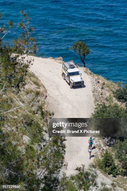 four wheel drive car and people walking near chrysochou bay in cyprus - four wheel drive imagens e fotografias de stock