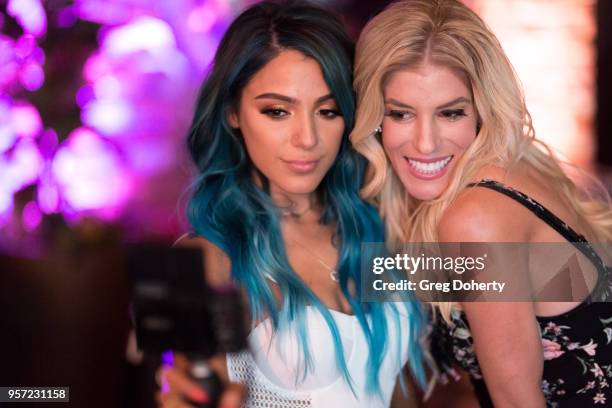 Niki DeMartino and Rebecca Zamolo take a selfie at the Niki & Gabi DeMartino X Bellami Collection Launch Party at Avenue on May 10, 2018 in Los...