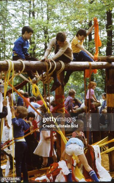 Volkskünstler gestalten zusammen mit Kindern einen Holzspielplatz aus Holz in Neustadt in Sachsen - er wird von den Kindern sogleich ausprobiert ,...