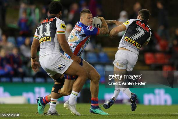 Shaun Kenny-Dowall of the Knights is tackled by the Panthers defence during the round 10 NRL match between the Newcastle Knights and the Penrith...