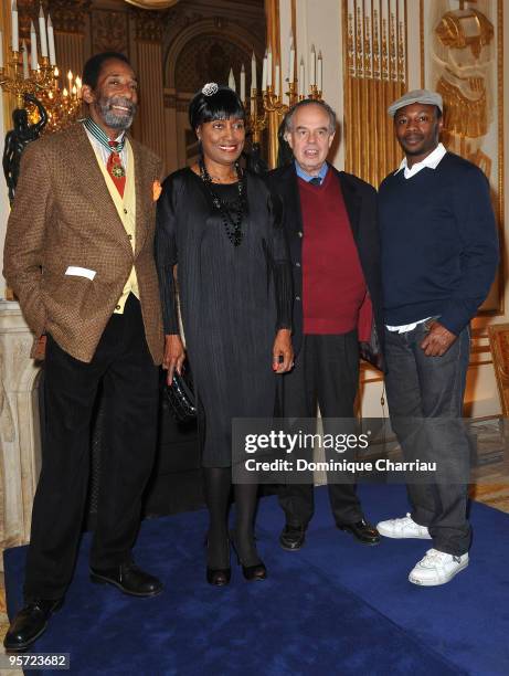 Ron Carter poses with his wife, Minister of Culture and Communication Frederic Mitterrand and Singer MC Solar after he received the French Order of...