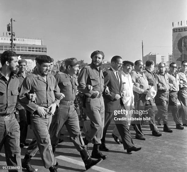 Cuban president Osvaldo Dorticos , prime minister Fidel Castro and other revolutionaries walk next to each other during a rally on occasion of Labour...