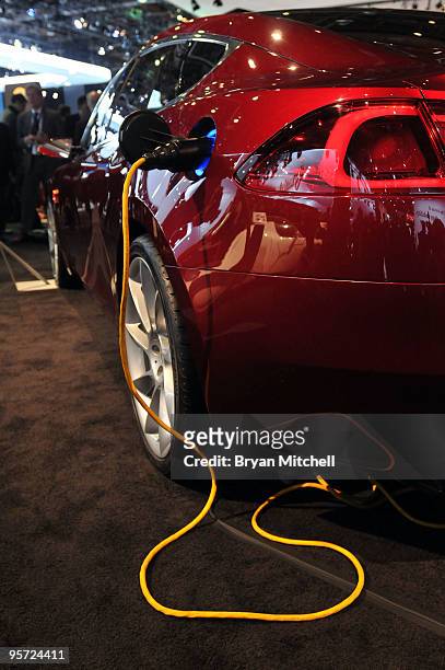 The Tesla Model S electric vehicle seen plugged in on the show floor during the press preview for the world automotive press at North American...