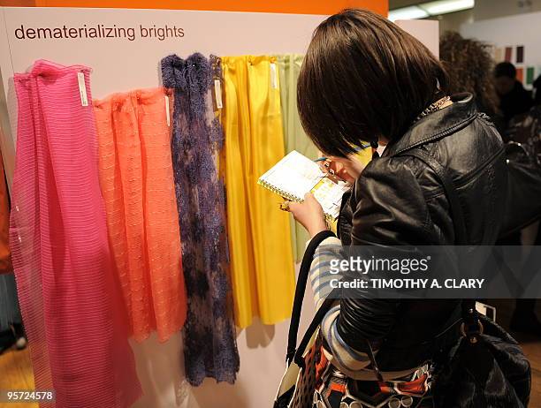 Member of the trade looks at fabric during the Première Vision Preview New York International Exhibition of Creative Textile Design January 12, 2010...