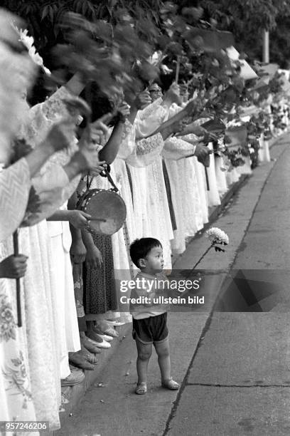 Jubelszenen am Straßenrand am Rande der XIII. Weltfestspiele der Jugend und Studenten im Juli 1989 in Pjöngjang. Auch dieser kleine Knirps mit Blume...