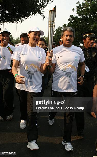 Anand Mahindra and Simi Garewal with the marathon flame in Mumbai on Sunday, January 10, 2010.