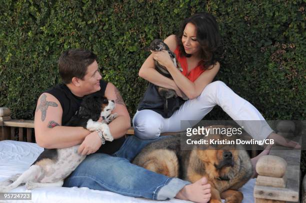 Chaz Bono and Jennifer Elia pose with dogs Lola, Rocco and Shorty during a photo shoot on October 22, 2009 in Los Angeles, Calofornia.