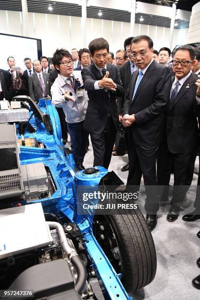Chinese Premier Li Keqiang visits the Toyota Motor Hokkaido facility in Tomakomai, Hokkaido prefecture on May 11, 2018. - Li, who is on a four-day...