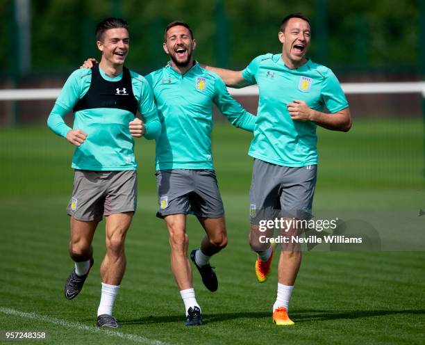 John Terry of Aston Villa in action with team mates Jack Grealish and Conor Hourihane during a training session at the club's training ground at The...